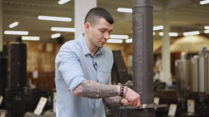 Чугунный дымоход с натрубным элементом из камня.