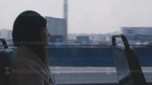 Girl looks out the window and rides a tram