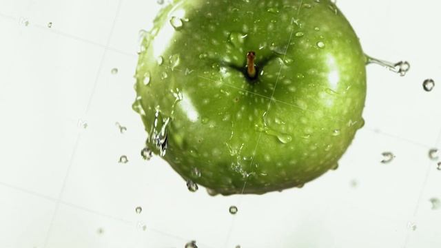 Flying of Green Apple in White Kitchen Background in Slow Motion смотреть онлайн