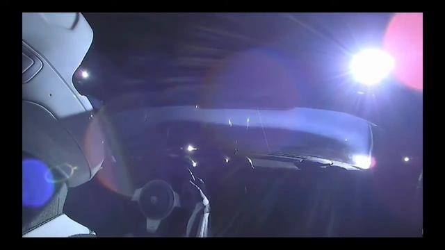 Tesla Roadster in space but with Grimes Oblivion playing on the back