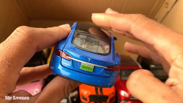 Box full of model Cars, BMW, Jaguar, Lexus 570, Dodge Charger, Ferrari, Tesla, Lamborghini.