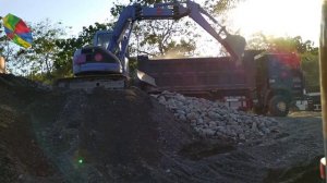 Komatsu PC75uu Excavator Loading Boulders on FAW J6P-350 Dump Truck