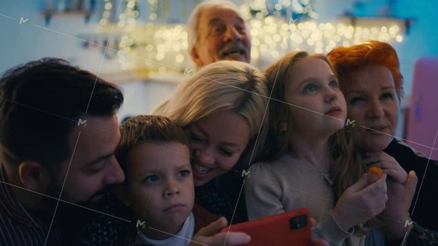 Excited family watching New Year fireworks in window