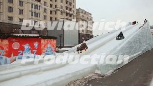 MOSCOW, RUSSIA - JANUARY 1, 2017: Snowy tubing slide. Children on the sled. New Year theme