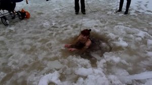 brave girl winter swimming under ice in Estonia