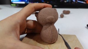 The process of sculpting a teddy bear from  clay/plasticine