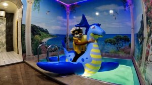 Riding on inflatable dragon in the pool