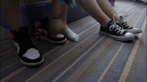 two girl takes off shoes and shows her soft feet.