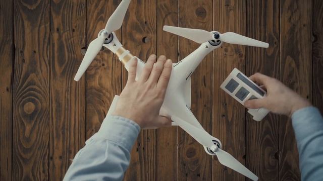 top view hands of aerial photographer remove dead exausted rechargeable lithium battery from white смотреть онлайн