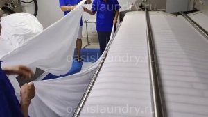 Проходной каландр в работе. Профессиональное оборудование для прачечных