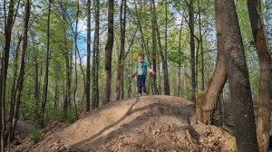 A child on a mountain jumps for joy