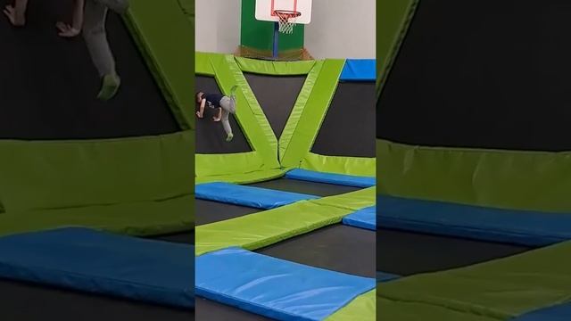 A child jumping on a trampoline at a trampoline playground