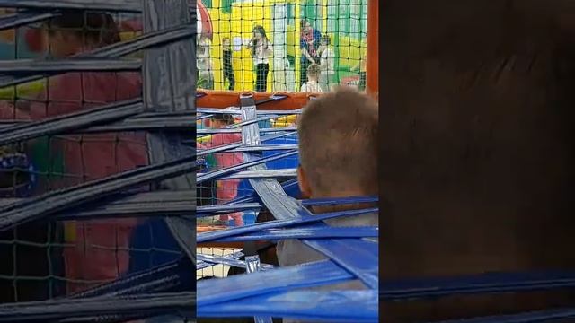 A child crawls through a maze on a playground