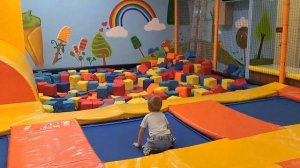A child is sliding down a slide on a playground