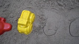 Sand grapes play in the sandbox with beach toys listen to a children's song