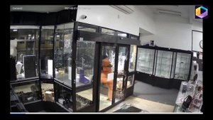 Moment man in orange boiler suit rams his way into jewellery store in Leongatha, Victoria.
