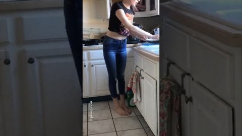 Girl pees in pants while doing dishes