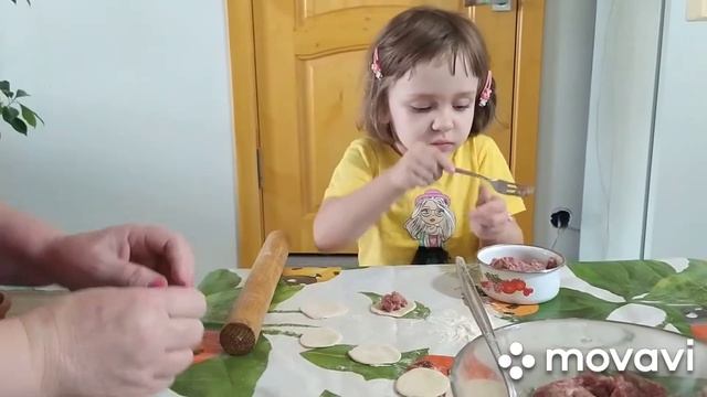Полина  Артемовна учится лепить пельмешки.