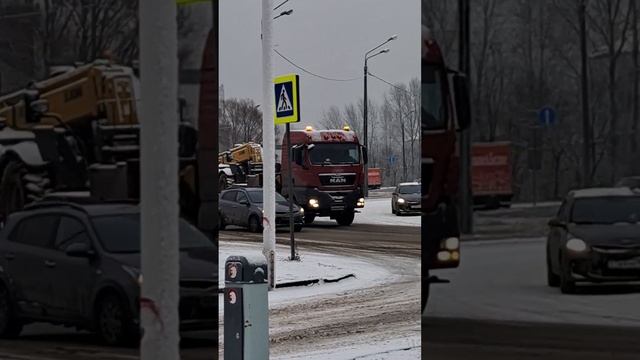 A truck carries a loader on a lowboy