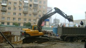 Экскаватор Volvo EC210B LC грузит самосвал Scania P380
