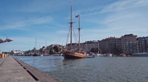 Helsinki, an old sailing ship sets sail from the pier.