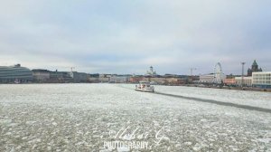 Winter Helsinki, ferry to Suomenlinna returns to Helsinki. Drone video.