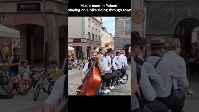 Music band in Poland playing on a bike riding through town смотреть онлайн