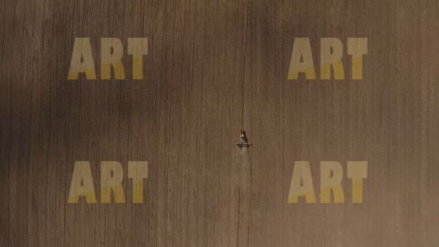 Tillage by tractor with attached cultivator aerial view. Agricultural business in agriculture.