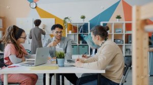 Slow motion of multi-ethnic business team discussing work in creative office