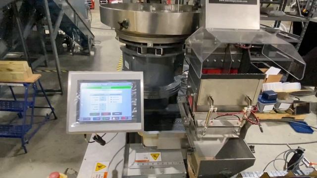 Fast Automatic Weigher filling 100 counts of 3/8" nuts into cartons at 12 batches per minute.