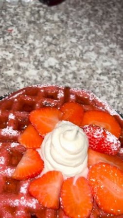 Red-velvet waffles & chicken tenders with cream cheese frosting in the middle & honey butter syrup