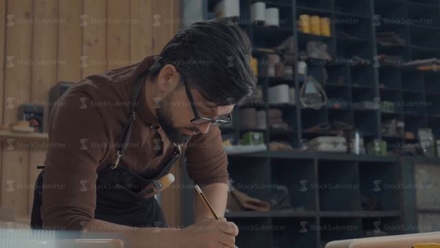 Bearded furniture designer draws a project, looking around for ideas. смотреть онлайн