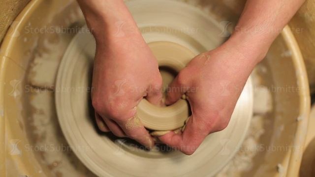 hands of a potter, creating an earthen jar on the circle смотреть онлайн