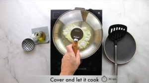 Eggs cooking in stainless steel pan with CRISTEL