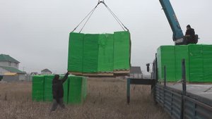 Разгрузка газосиликатных блоков (пеноблок) Технология HEBEL завод ЛЗИД подъемным краном в поле.
