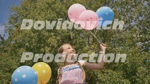 Young girl with airy colored balls smiling and posing on camera. Good mood and positive