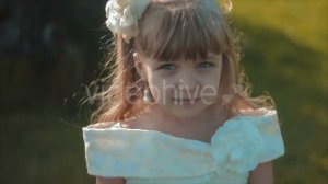 Little Girl in White Smiling to Camera