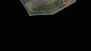 mixkit-banknotes-falling-on-a-dark-background-18305-hd-ready