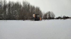 За огородом.