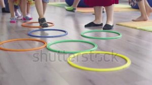 stock-footage-small-nursery-school-children-with-female-teacher-on-floor-indoors-in-classroom-doing-