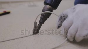 stock-footage-master-welding-machine-type-construction-dryer-solders-two-pieces-of-linoleum-using-a-