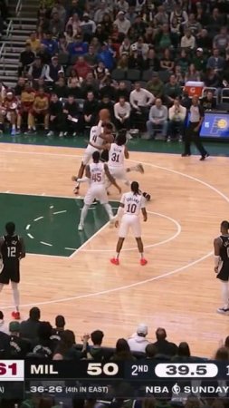 Giannis splits two defenders for the slam