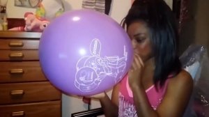 girl blowing up Mellyloon balloon