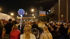 Толпа людей идет по трассе после светового шоу в Москве