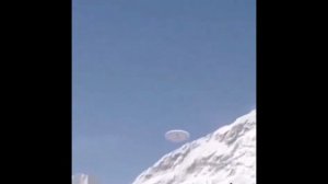 Туристам в горах Китая удалось запечатлеть медленно парящий дискообразный НЛО, улетающий за гору.