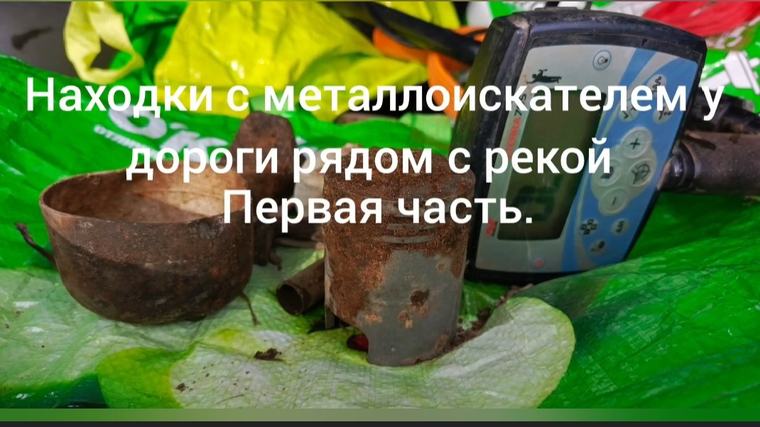 поиск монет с металлоискателем у дороги рядом с рекой.