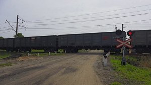 Russian freight train at the railroad crossing / Грузовой поезд проходит жд переезд