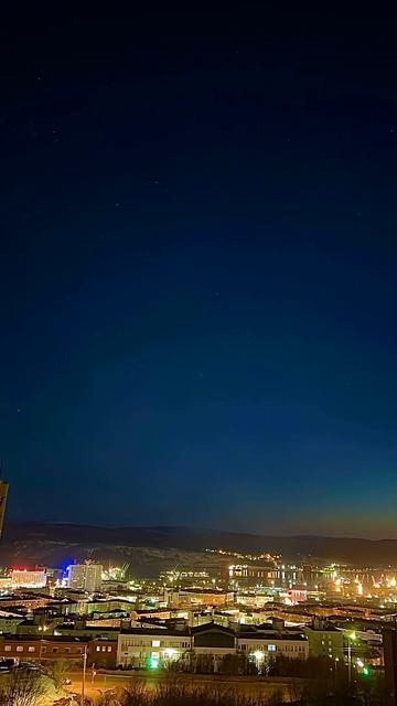 16 апреля 2023 aurora borealis over the center of Murmansk f windows of  buildings  Kola Bay Video