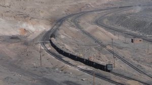 Sandaoling mine pit from above, two trains, one coal, the other rock for the spoil tip dumping.
