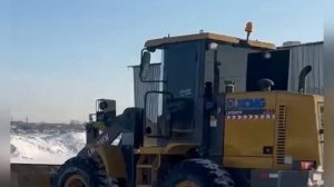 Front Loader XCMG 300 LW is cleaning snow